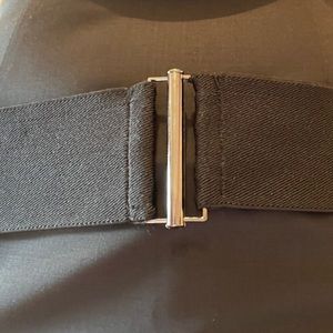 Black elastic belt with slide and lock clasp.